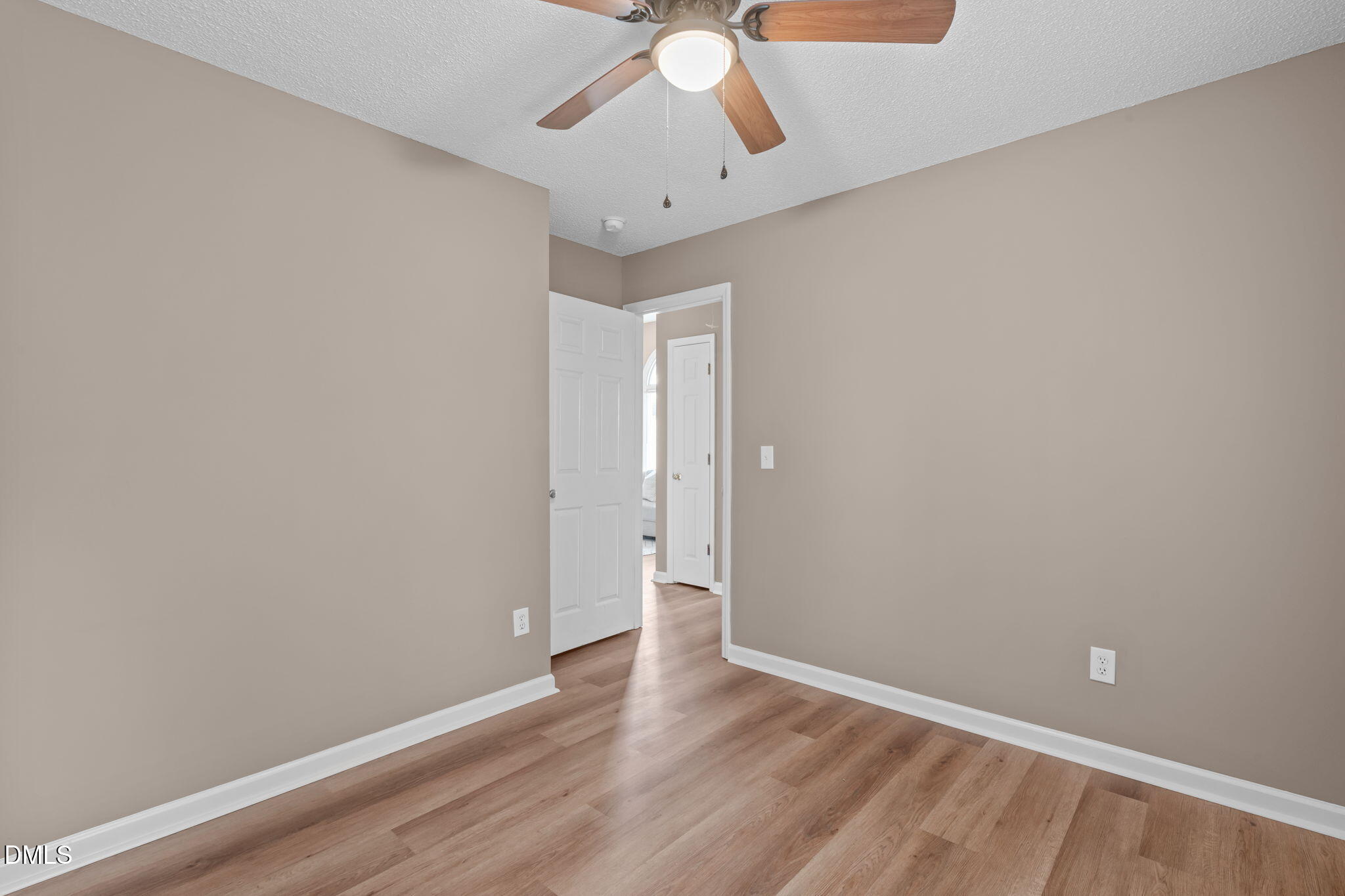 420 Johnson Street Garner, NC 27529 - Photo 32 of 43 a view of an empty room with window and wooden floor