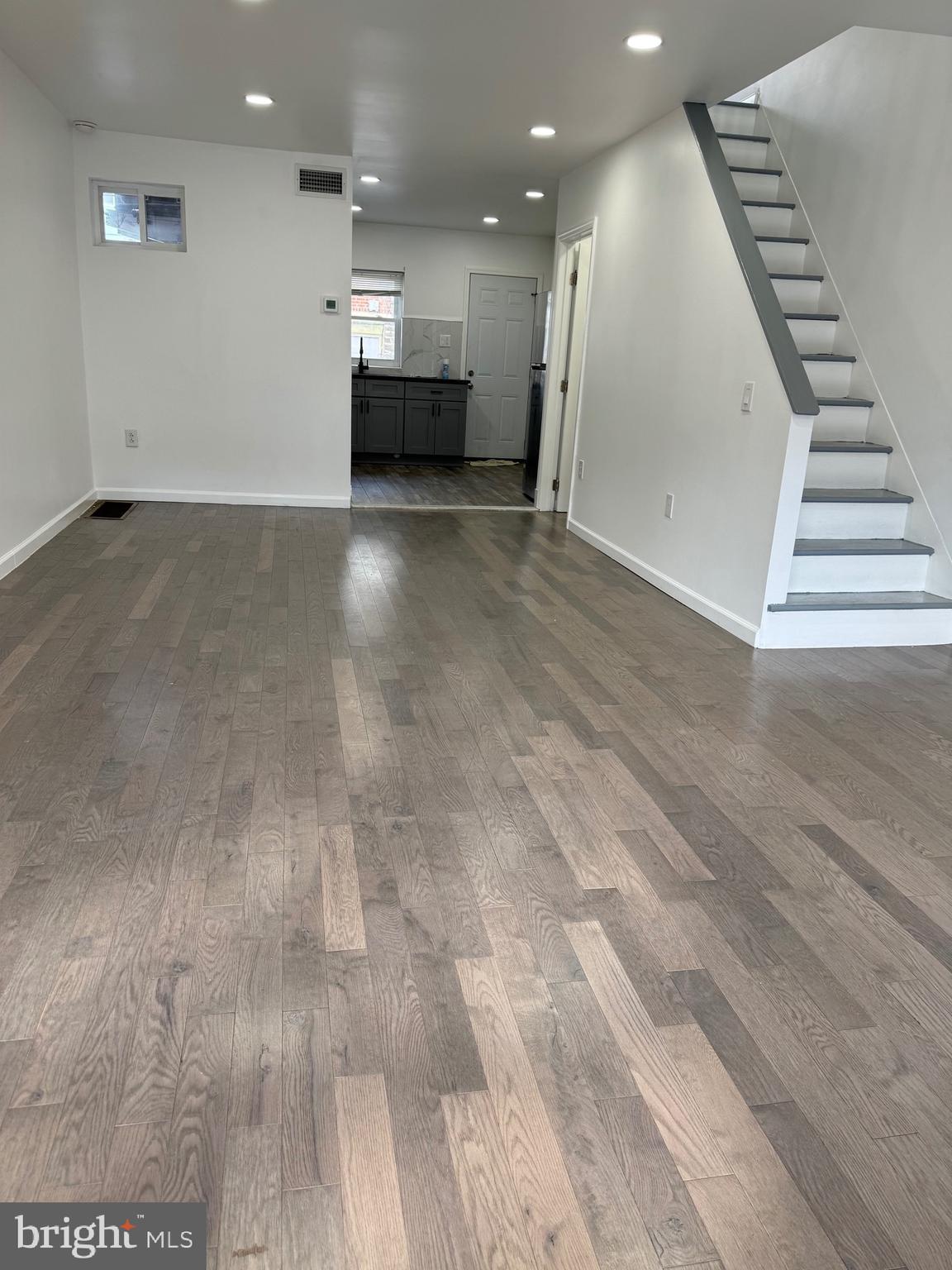 139 Rosemar Street Philadelphia, PA 19120 - Photo 2 of 19 an empty room with wooden floor and staircase