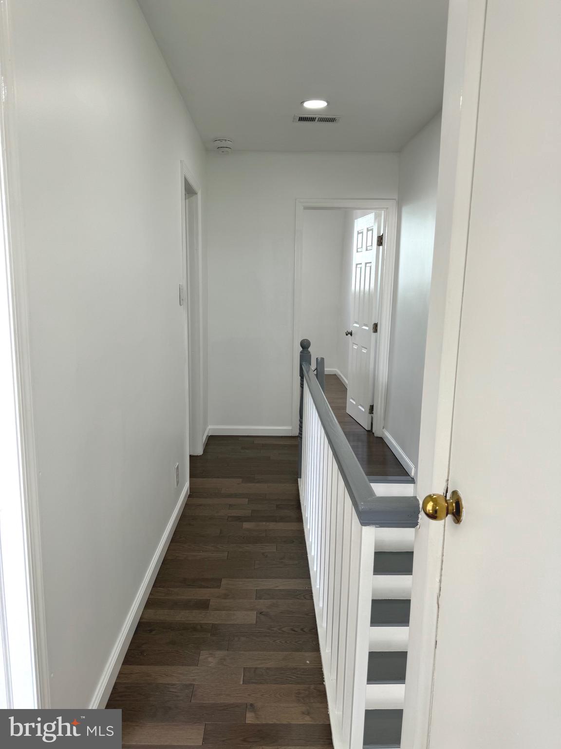 139 Rosemar Street Philadelphia, PA 19120 - Photo 9 of 19 a view of a hallway with wooden floor and staircase