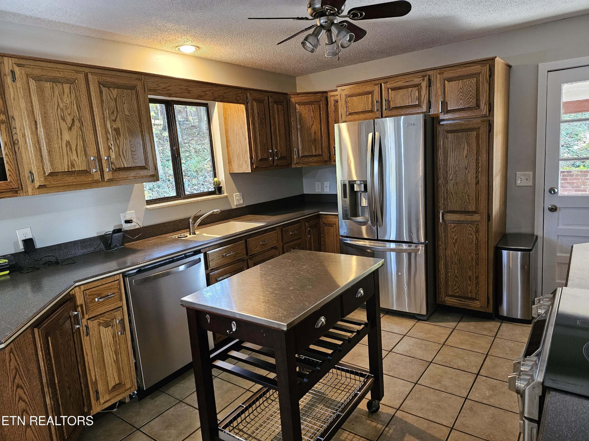 20 Clark Place Oak Ridge, TN 37830 - Photo 13 of 51 a kitchen with stainless steel appliances granite countertop a refrigerator a sink a stove and island