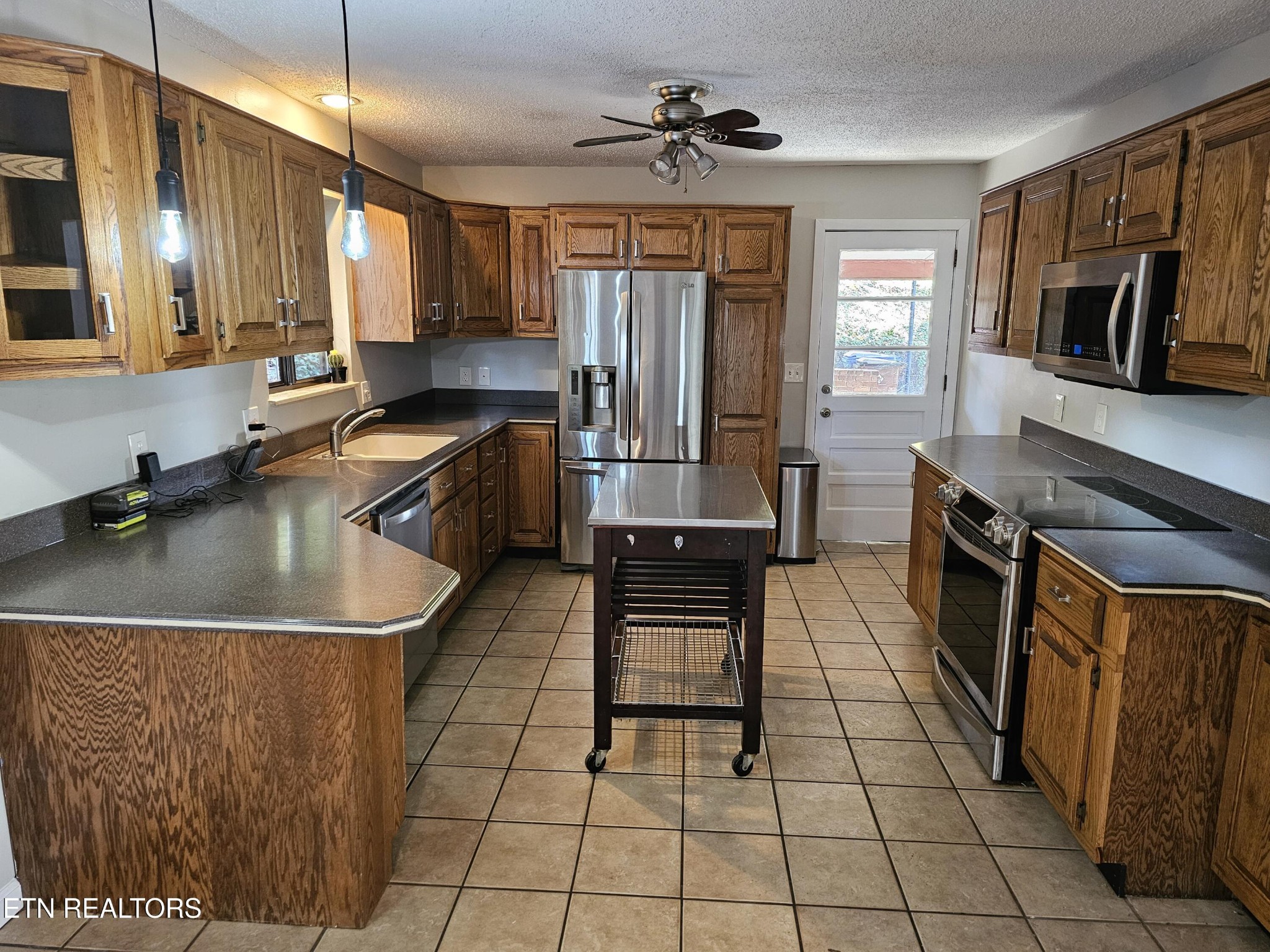 20 Clark Place Oak Ridge, TN 37830 - Photo 14 of 51 a kitchen with stainless steel appliances granite countertop a sink a stove and a microwave