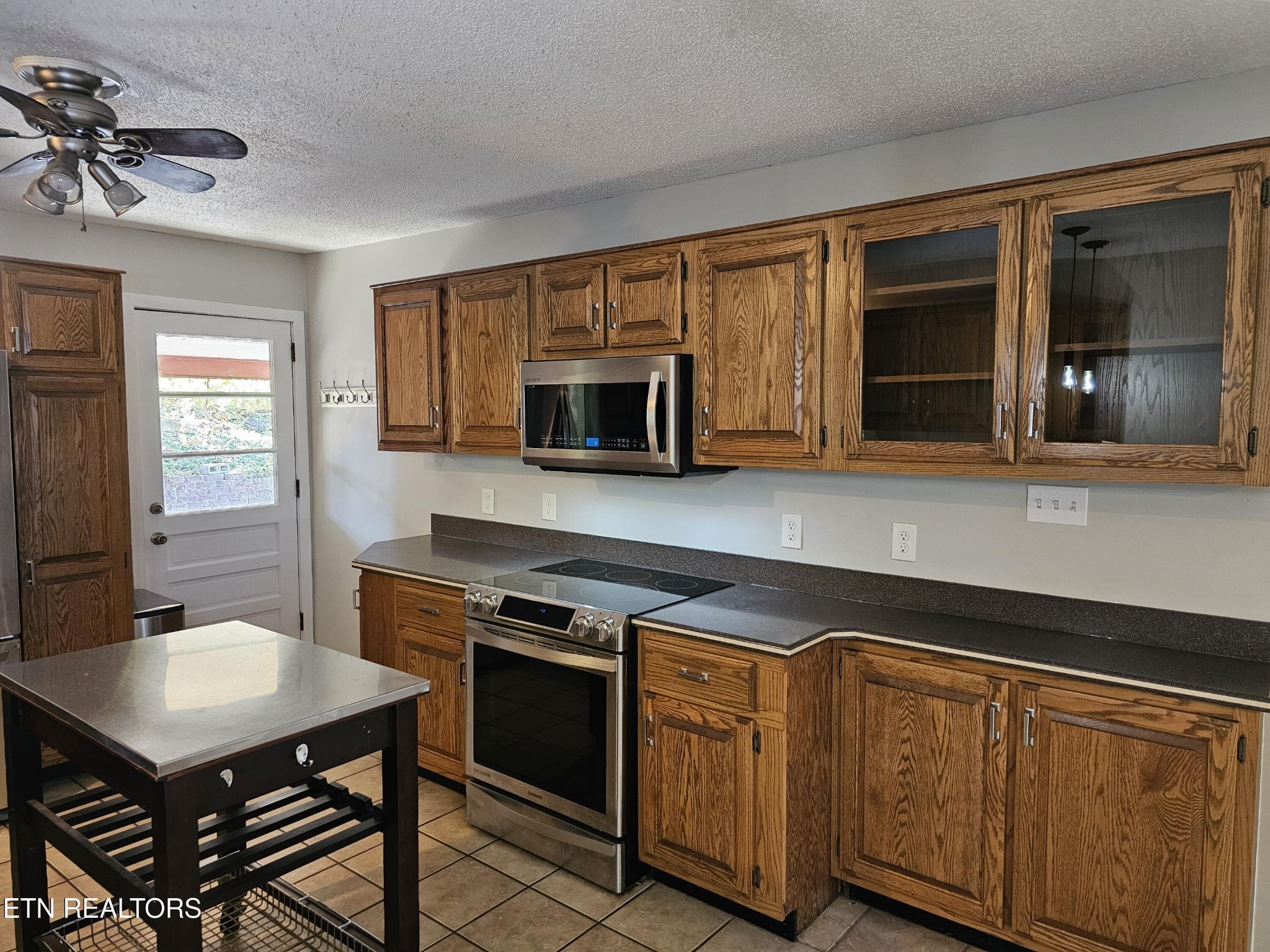 20 Clark Place Oak Ridge, TN 37830 - Photo 15 of 51 a kitchen with a stove cabinets and a window