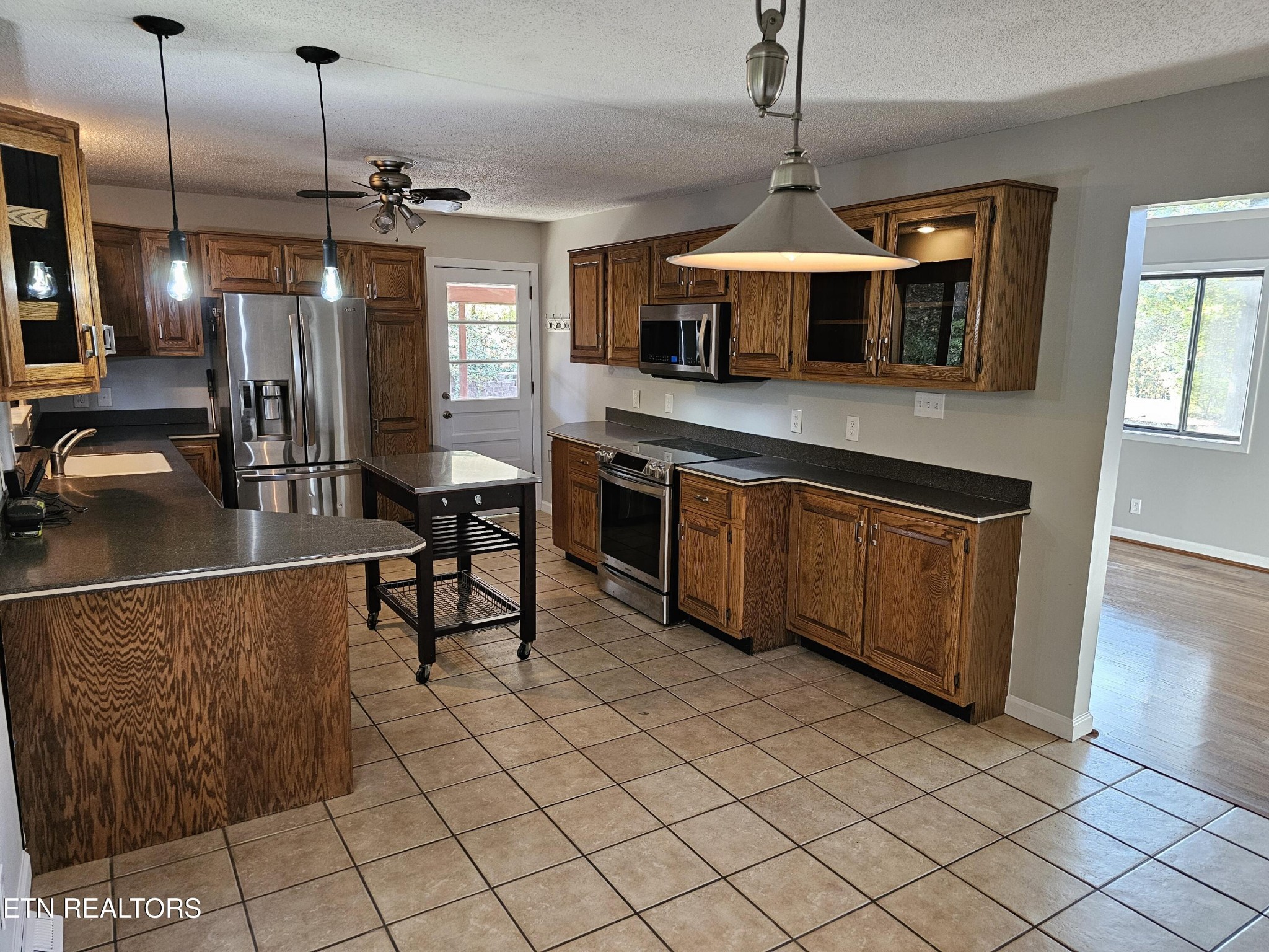 20 Clark Place Oak Ridge, TN 37830 - Photo 16 of 51 a kitchen with stainless steel appliances granite countertop a stove a sink and a refrigerator