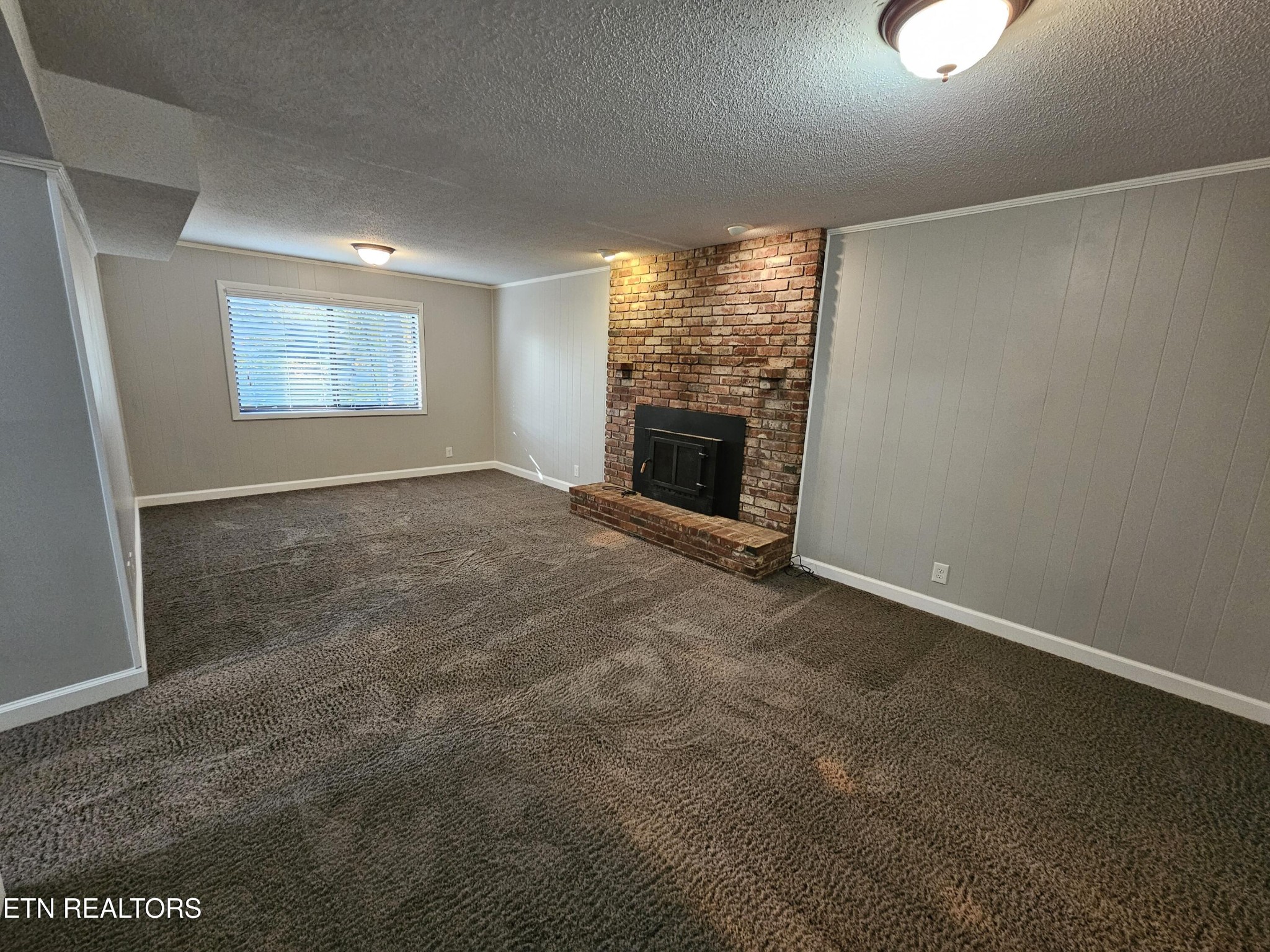 20 Clark Place Oak Ridge, TN 37830 - Photo 36 of 51 a view of an empty room with a fireplace and a window