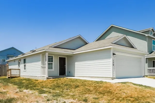 a view of house with yard and garage