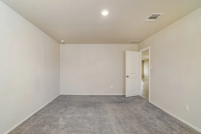 a bathroom with a granite countertop sink a mirror and a toilet