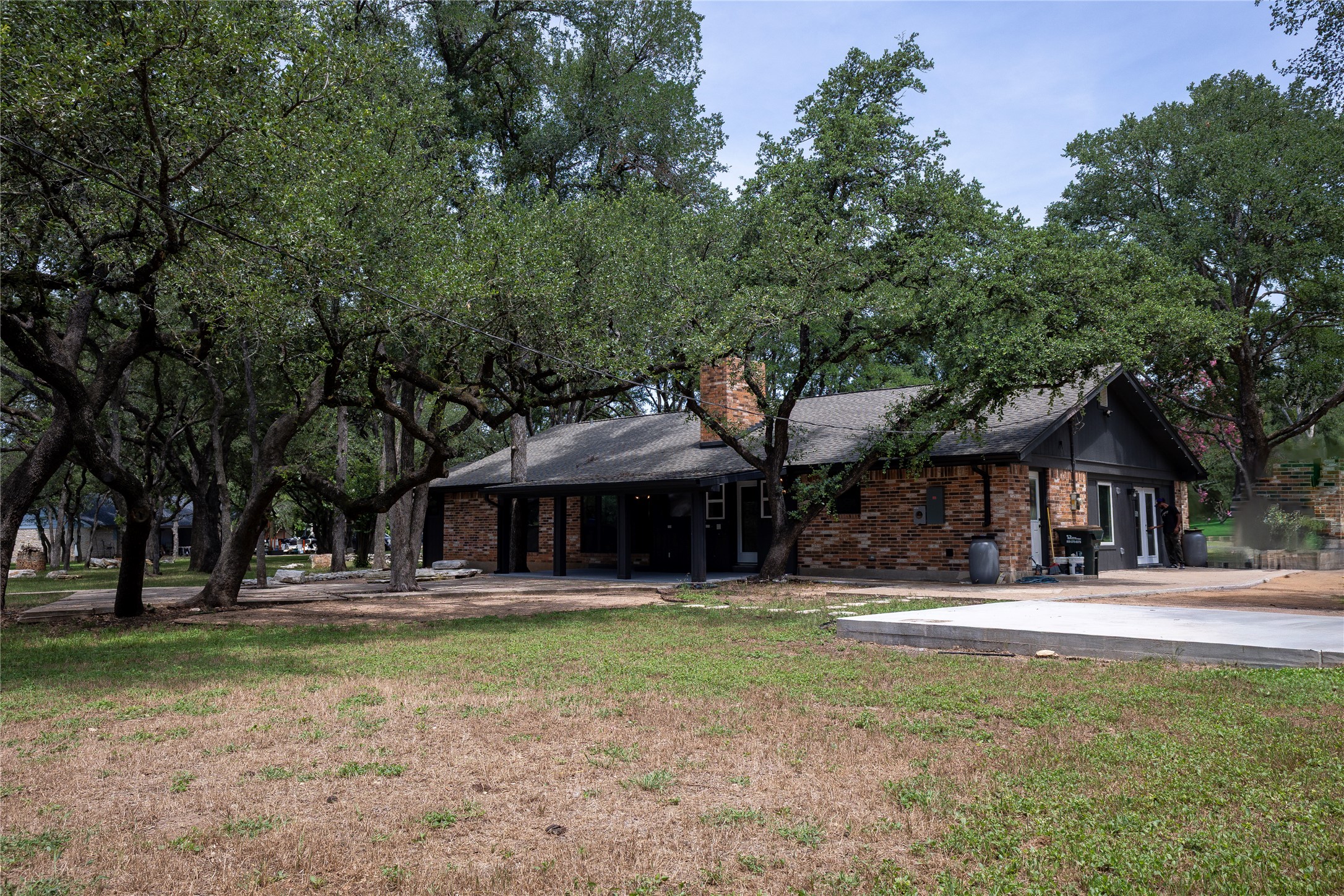 205 Bello Circle Georgetown, TX 78628 - Photo 34 of 36 Mature trees canopy this brick residence, offering ample shade for outdoor enjoyment.