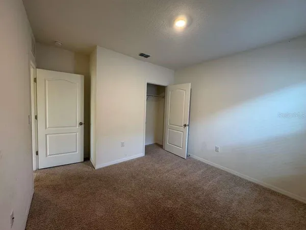 an empty room with closet area