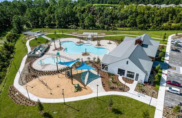 an aerial view of a house having swimming pool having outdoor seating