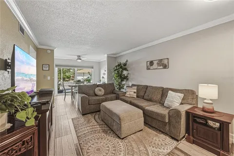 a view of a patio with couches table and chairs and potted plants