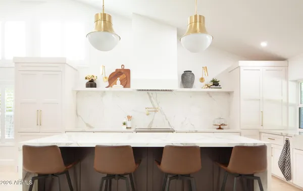 a table with chairs and white cabinets
