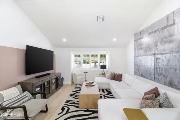 a large kitchen with kitchen island a large counter space a large window and stainless steel appliances