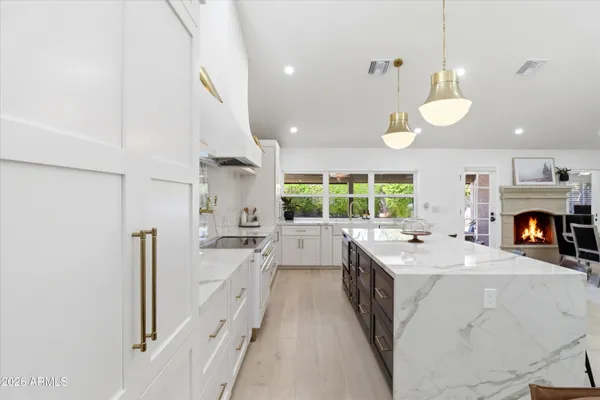 a large kitchen with lots of counter space and dining table