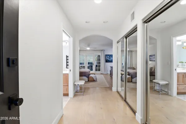a bedroom with a large bed and a flat screen tv