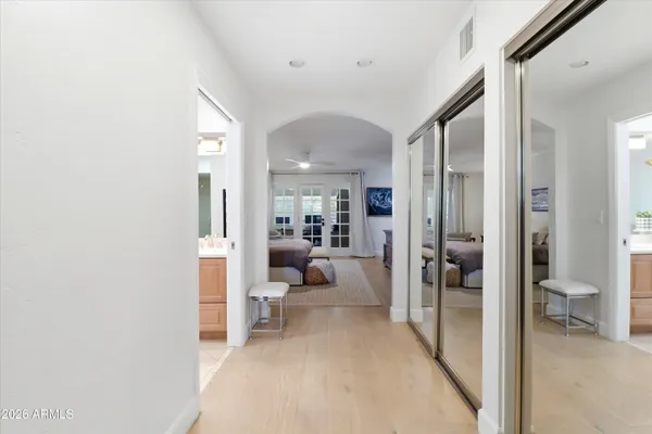 a bedroom with a large bed and a flat screen tv