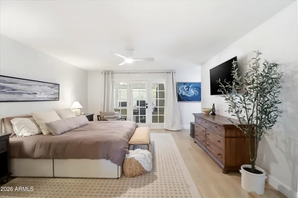 a spacious bedroom with a bed and a couch