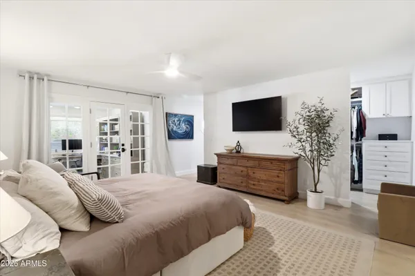 a bedroom with a bed and a window