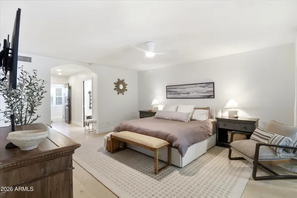 a bedroom with two beds and a lamp