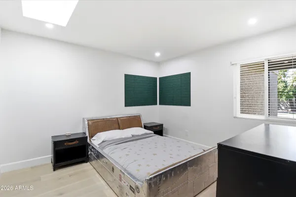 a bedroom with two beds and a window