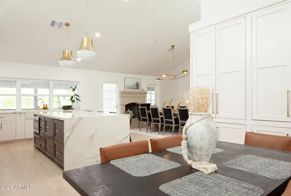 a living room with furniture a large window and kitchen view
