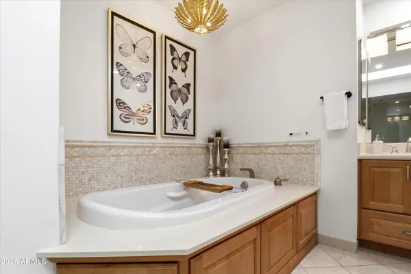 a white toilet sitting next to a wooden cabinet