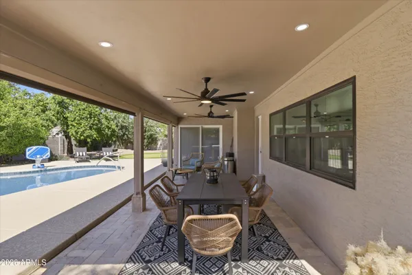 a view of a swimming pool with an outdoor seating and a garden