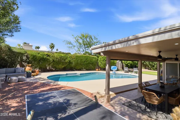 a view of a swimming pool with a patio