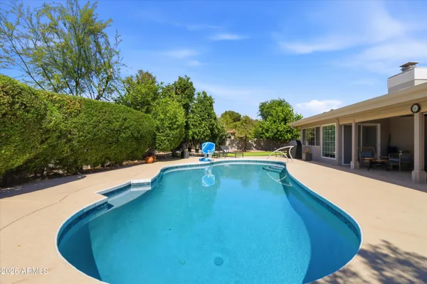 a view of a swimming pool with a patio