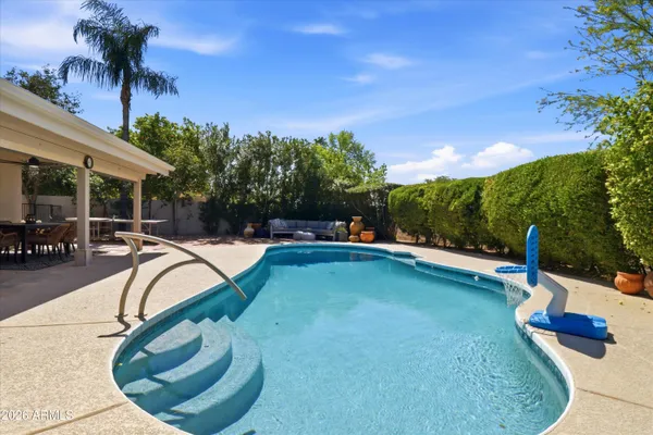 a view of a swimming pool with a yard