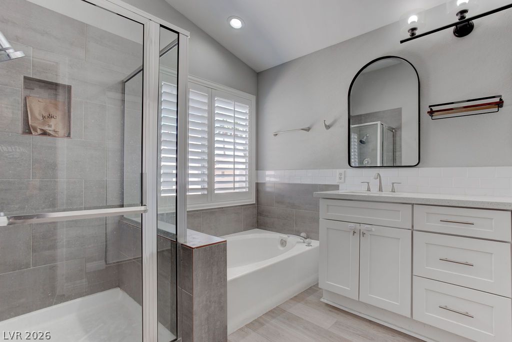 1416 Walstone Road North Las Vegas, NV 89031 - Photo 38 of 47 A well-appointed bath features a deep soaking tub, glass-enclosed shower, and sleek vanity.