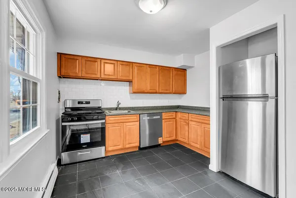 a kitchen with stainless steel appliances granite countertop a refrigerator and a sink