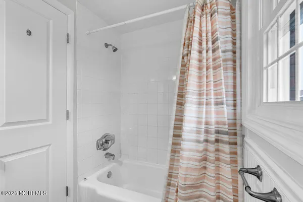 a bathroom with a bathtub and shower