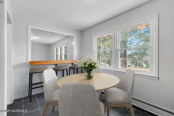 a view of a dining room with furniture and window