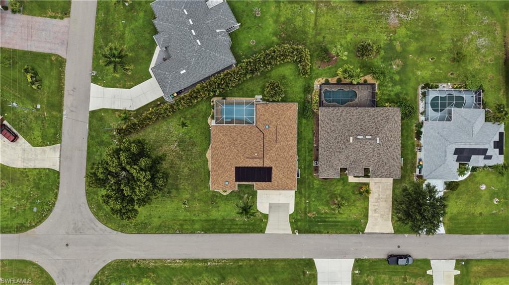 25378 Rupert Road Punta Gorda, FL 33983 - Photo 3 of 50 Aerial perspective of a property featuring a screened-in swimming pool and solar panels on the roof