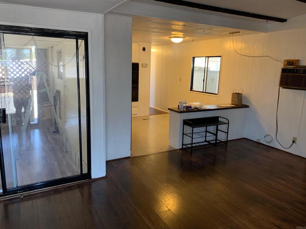 7 Lynn Lane Oceanside, CA 92058 - Photo 3 of 9 a view of a hallway with wooden floor and a bathroom