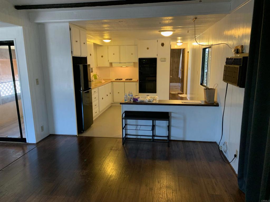 7 Lynn Lane Oceanside, CA 92058 - Photo 4 of 9 a view of a hallway with furniture and wooden floor