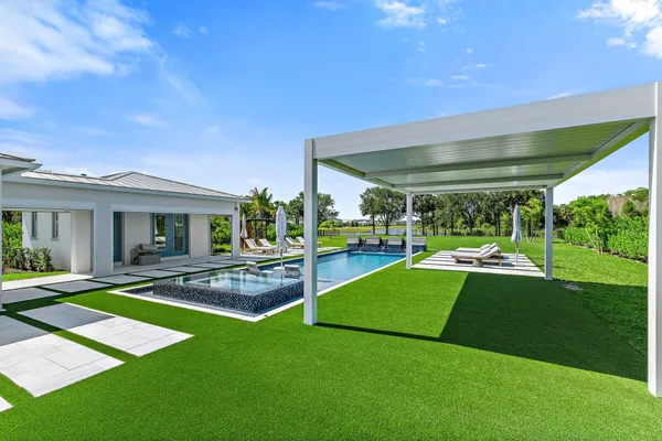 an aerial view of a house with yard swimming pool and outdoor seating