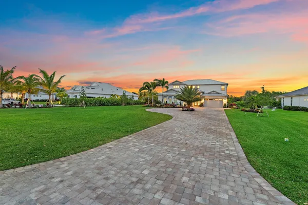 a spacious bedroom with a large bed and a chandelier