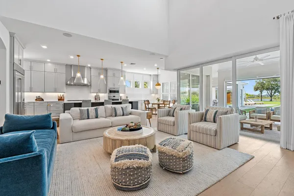 a view of a dining room with furniture and chandelier