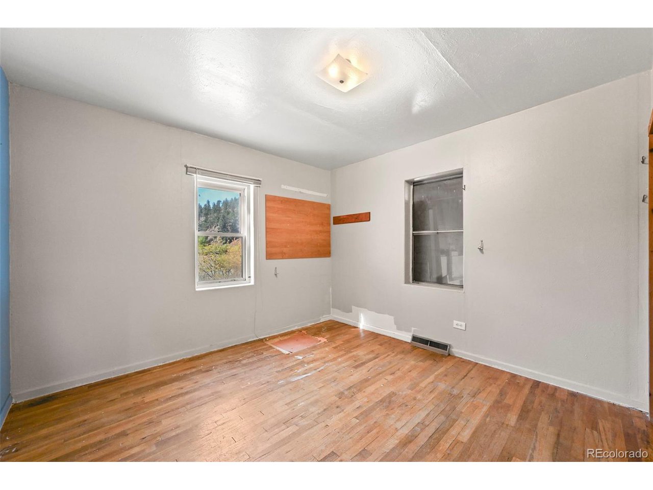 2677 South Platte River Road Sedalia, CO 80135 - Photo 14 of 42 a view of an empty room with wooden floor and a window
