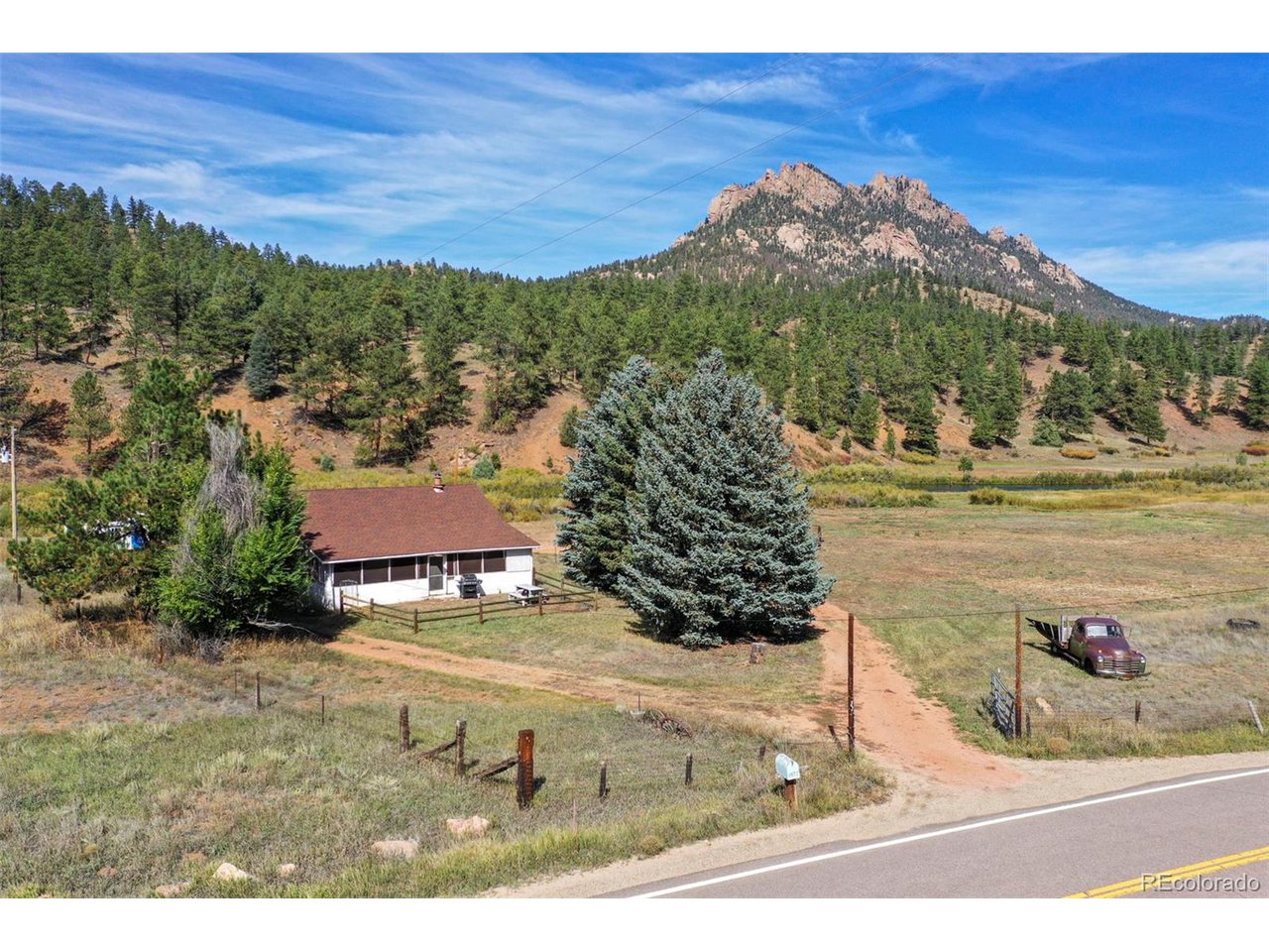 2677 South Platte River Road Sedalia, CO 80135 - Photo 25 of 42 a view of a town with mountains in the background