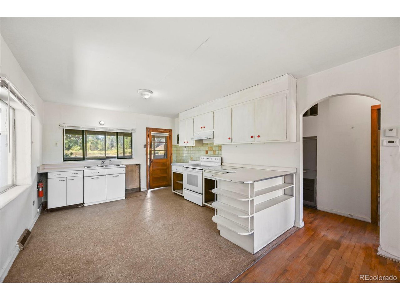 2677 South Platte River Road Sedalia, CO 80135 - Photo 10 of 42 a kitchen with stainless steel appliances a refrigerator and cabinets