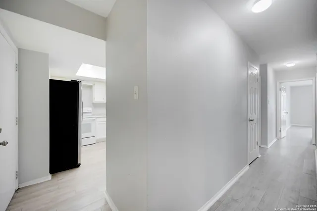 a view of hallway with wooden floor