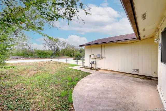 a view of a backyard with sitting area