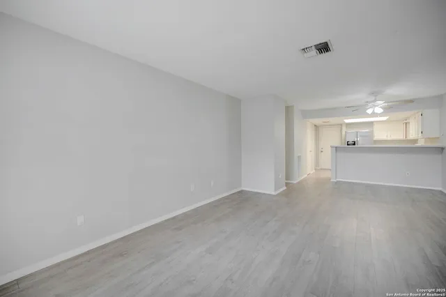 a view of a kitchen with wooden floor and a sink