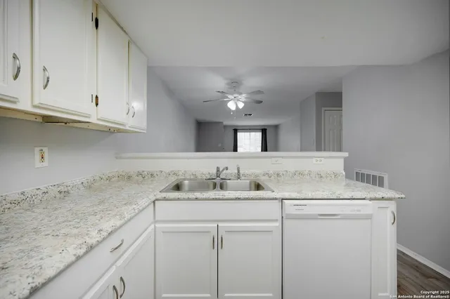 a kitchen with a sink and cabinets