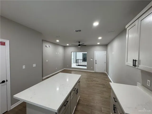 a kitchen with stainless steel appliances granite countertop a refrigerator sink and stove