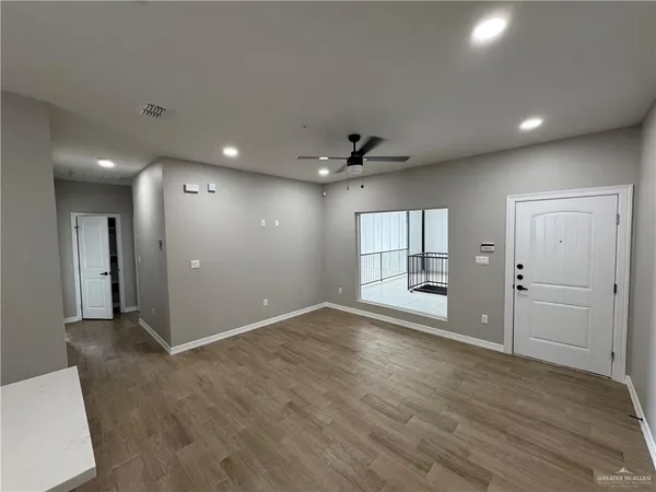 a kitchen with a sink dishwasher a stove and a refrigerator with wooden floor