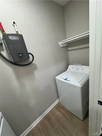 a view of a hallway to a livingroom with furniture