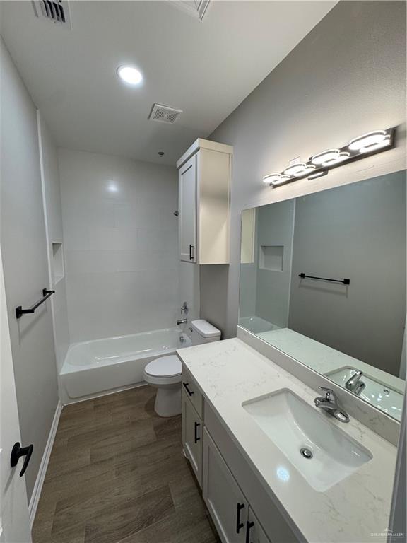 800 Ragland Road, Unit 9 Mission, TX 78572 - Photo 9 of 16 a bathroom with a double vanity sink toilet and shower